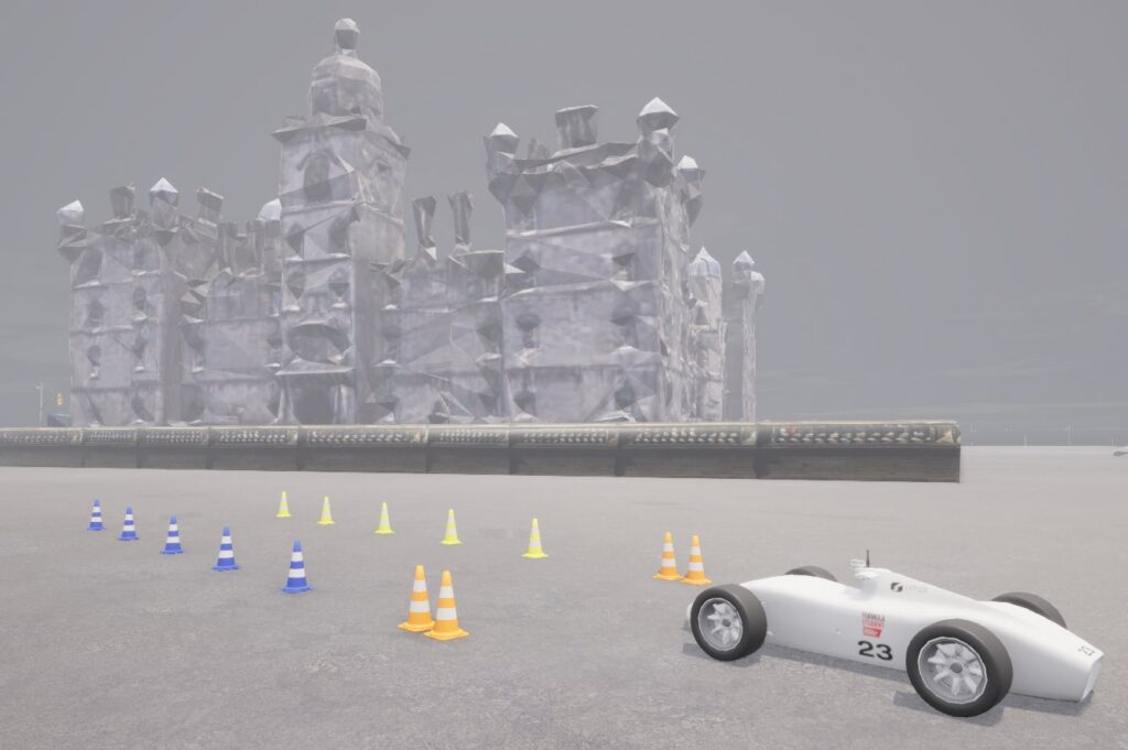 A synthetic environment containing a racecar, cones, and a simple background.
